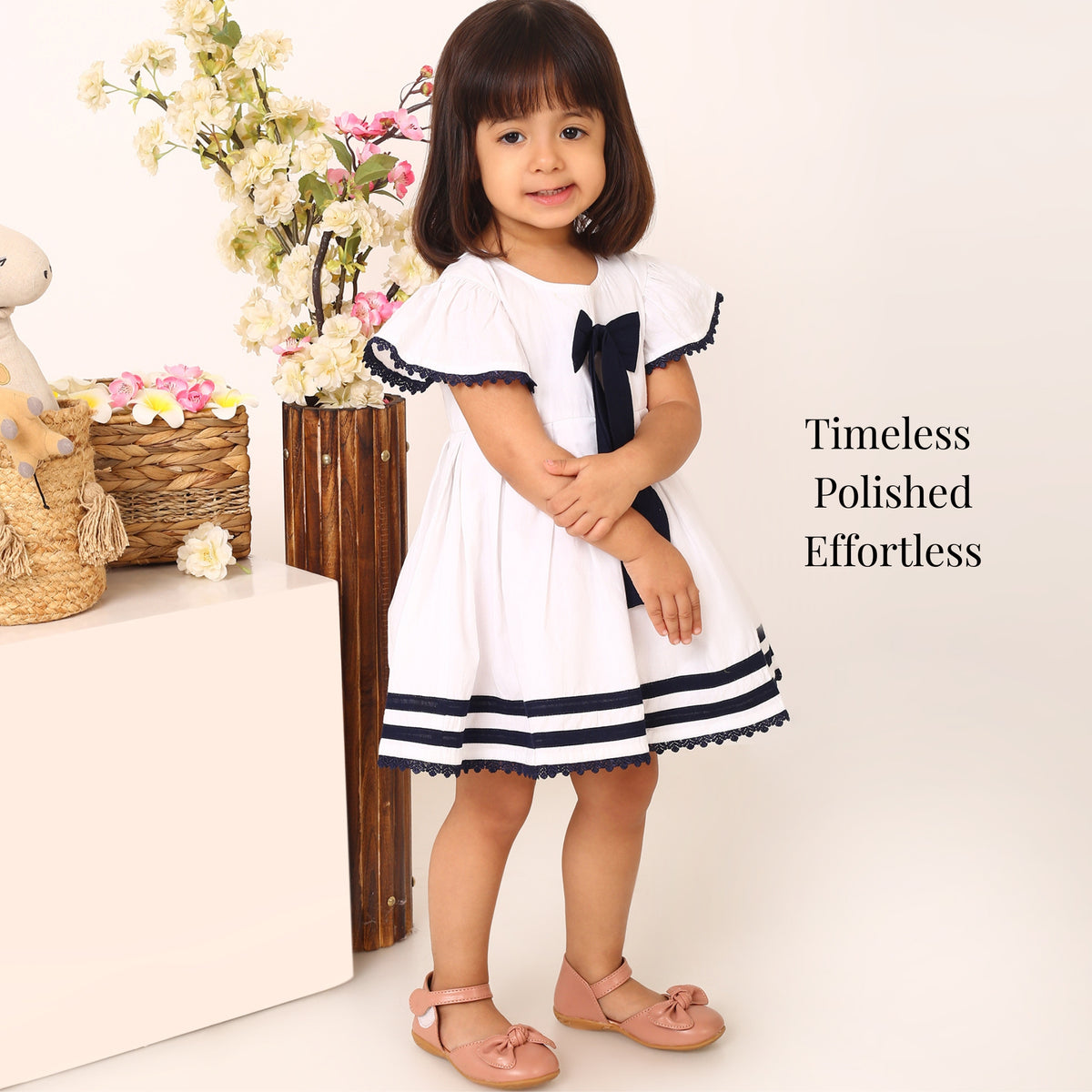 White cotton party dress for girls with navy bow