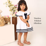White cotton party dress for girls with navy bow